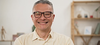 a smiling man with glasses